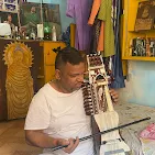 A student working on advanced melodic harmonium raag scales